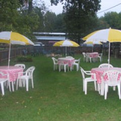 a group of lawn chairs under an umbrella