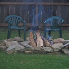 a group of lawn chairs sitting on top of a wooden fence