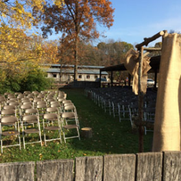 a group of people standing on top of a wooden fence