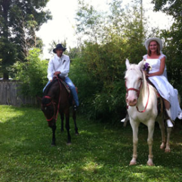 a group of people standing next to a horse
