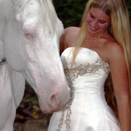 a person standing next to a horse