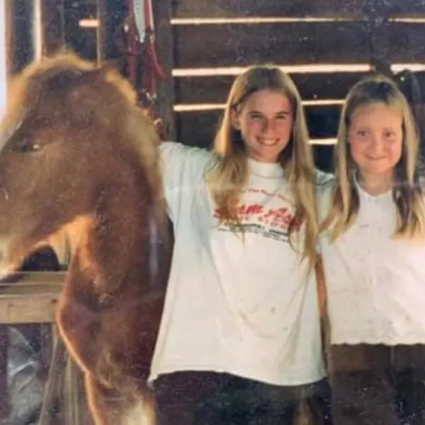 a man standing next to a horse