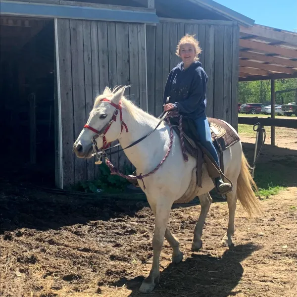 a person riding a horse in a dirt field