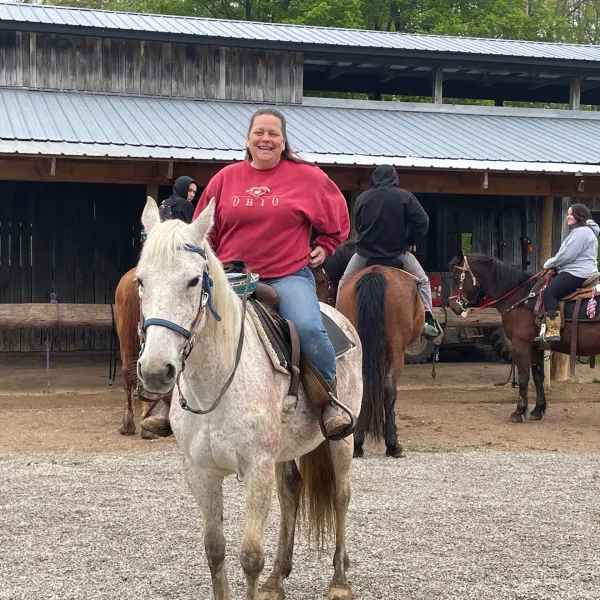 a man riding a horse in front of a building