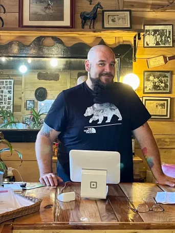 a man standing in front of a table