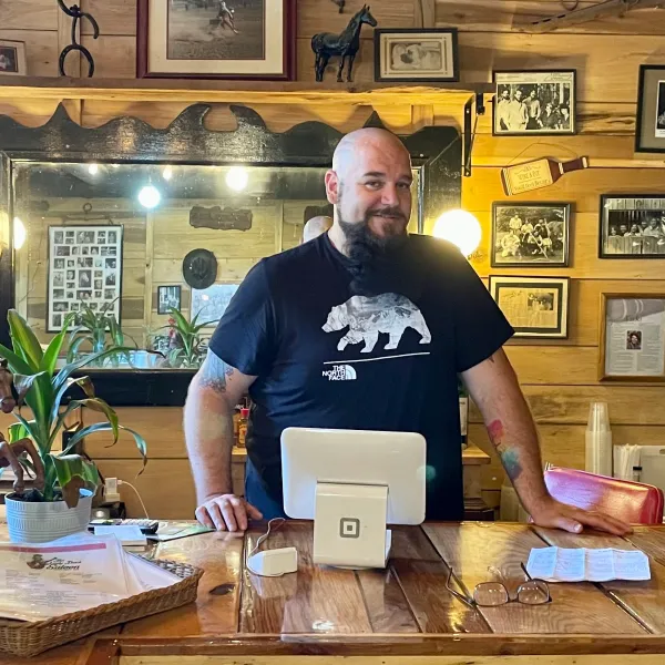 a man standing in front of a table
