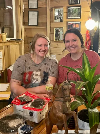 a man and a woman sitting at a table posing for the camera