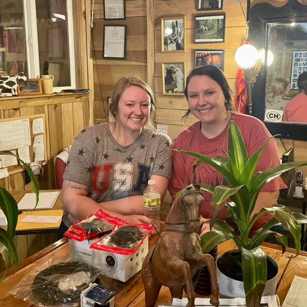 a man and a woman sitting at a table posing for the camera