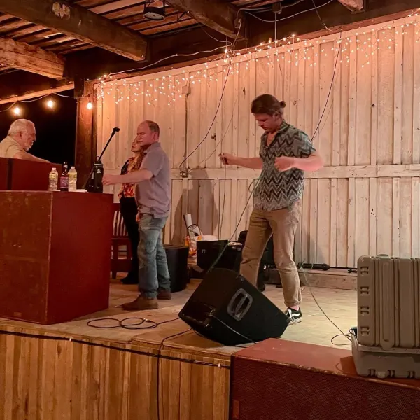a group of people standing on top of a wooden table